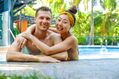 Beautiful photo of happy couple in the pool chatting with each other. stock images Beautiful photo of happy couple in the pool chatting with each other. stock images