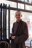 Smiling monk in a restaurant in Prague.