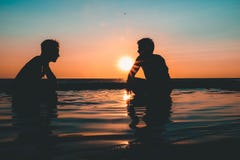 Photo of Two Men on Seashore during Sunset Stock Photo Photo of Two Men on Seashore during Sunset Stock Photo