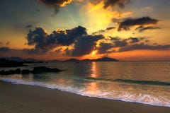 Nature Seascape with Tranquil Beach, Rocks, Islands and Bursting Sun at Sunrise royalty free stock images Nature Seascape with Tranquil Beach, Rocks, Islands and Bursting Sun at Sunrise royalty free stock images
