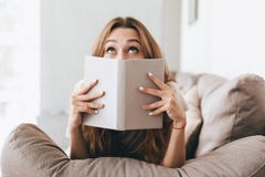 Pretty lady covering face with book. royalty free stock photo Pretty lady covering face with book. royalty free stock photo