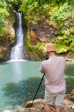 Photographer taking photo of Chamouze waterfall. Mauritius royalty free stock photography Photographer taking photo of Chamouze waterfall. Mauritius royalty free stock photography