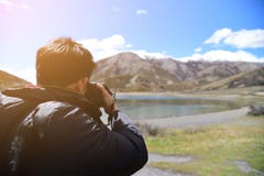Photographer taking photo of landscape Photographer taking photo of landscape