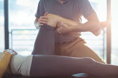 Physiotherapist giving knee therapy to a woman stock photography Physiotherapist giving knee therapy to a woman stock photography