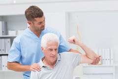 Physiotherapist giving physical therapy to man