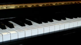 Piano keys close up with black and white keyboard and left pan. Piano keys close up with black and white keyboard and pan to left Piano keys close up with black and white keyboard and left pan. Piano keys close up with black and white keyboard and pan to left