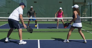 Pickleball - Two Couples Congratulating Each Other After A Game Well Played Stock Photo Pickleball - Two Couples Congratulating Each Other After A Game Well Played Stock Photo