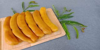 Pickled tamarind : preserved sweet tamarind fruit on gray background. royalty free stock photography Pickled tamarind : preserved sweet tamarind fruit on gray background. royalty free stock photography