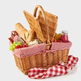 Picnic basket packed with a tasty summer lunch stock images Picnic basket packed with a tasty summer lunch stock images