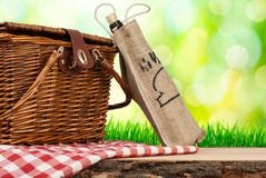 Picnic basket on the table and bottle of wine royalty free stock photography Picnic basket on the table and bottle of wine royalty free stock photography