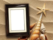 Picture frame on shells and sand background stock photos Picture frame on shells and sand background stock photos
