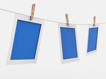 Picture frame and white backgroundPhoto frames hang with laundry clamps on a white background 3D rendering royalty free illustration Picture frame and white backgroundPhoto frames hang with laundry clamps on a white background 3D rendering royalty free illustration