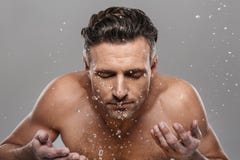 Handsome mature man washing his face. Stock Photography Handsome mature man washing his face. Stock Photography