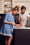 Picture of happy loving couple cutting vegetables in kitchen