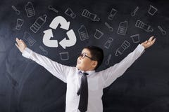 Happy schoolboy showing recycle sign stock photos Happy schoolboy showing recycle sign stock photos