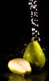 Pear under sparking water jets stock photo Pear under sparking water jets stock photo