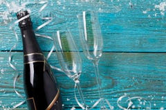 Picture of two wineglasses, bottle of champagne, white ribbons,