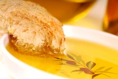 Piece Of Crusty Bread In A Bowl Of Olive Oil Stock Photo