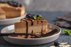Piece of raw vegan chocolate-caramel cheesecake with blueberries royalty free stock image Piece of raw vegan chocolate-caramel cheesecake with blueberries royalty free stock image