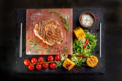 Pieces of roast beef with spices served on black slate. stock photography Pieces of roast beef with spices served on black slate. stock photography
