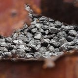 A pile of coal behind a rusty metal wall royalty free stock photos A pile of coal behind a rusty metal wall royalty free stock photos