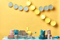 Pile of dirty colorful kitchenware in yellow background royalty free stock image Pile of dirty colorful kitchenware in yellow background royalty free stock image