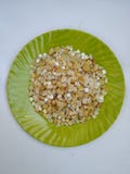 Pile of a Pongal Traditional Raw Mixtures of Ellu Bella in a Green Plate isolated on white Background