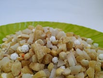 Pile of a Pongal Traditional Raw Mixtures of Ellu Bella in a Green Plate isolated on white Background