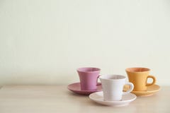 Pile Of Colorful Vintage Cups Of Coffee On Wooden Table Royalty Free Stock Photography