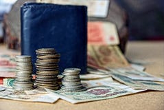 Piles of old coins on paper bills near the purse royalty free stock images Piles of old coins on paper bills near the purse royalty free stock images