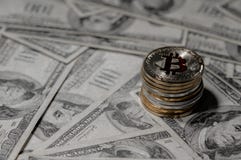 Pilha de empilhar o bitcoin dourado em cem cédulas do dólar única moeda que enfrenta a câmera no foco afiado imagem de stock royalty free Pilha de empilhar o bitcoin dourado em cem cédulas do dólar única moeda que enfrenta a câmera no foco afiado imagem de stock royalty free
