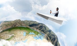 Pilot in leather helmet driving paper plane stock photo Pilot in leather helmet driving paper plane stock photo