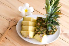Pineapple slices on the white dish on the wood. Stock Image Pineapple slices on the white dish on the wood. Stock Image