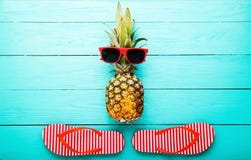 Pineapple With Glasses And Slippers On Blue Wooden Background. Copy Space And Top View Stock Photography Pineapple With Glasses And Slippers On Blue Wooden Background. Copy Space And Top View Stock Photography