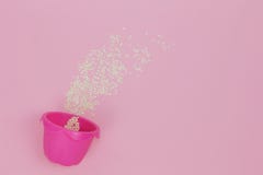 Pink baking cup on the pink background sprinkled with sesame royalty free stock image Pink baking cup on the pink background sprinkled with sesame royalty free stock image