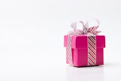 Pink gift box tied with white red stripe ribbon stock photo Pink gift box tied with white red stripe ribbon stock photo