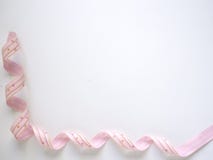 Pink curly ribbon on a white stock image Pink curly ribbon on a white stock image