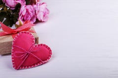 Pink felt heart, flowers and handmade gift on a white wooden table, Concept, banner, save space stock photography Pink felt heart, flowers and handmade gift on a white wooden table, Concept, banner, save space stock photography