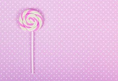 Pink lollipop. Pink paper background. Pink polka dot background. royalty free stock photography Pink lollipop. Pink paper background. Pink polka dot background. royalty free stock photography