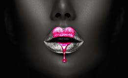 Pink Paint lipgloss drops on sexy lips, bright liquid paint on beautiful model girl\'s mouth. Valentine\'s Day