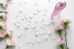 A Pink perfume bottle with pink and white carnation flowers royalty free stock photo A Pink perfume bottle with pink and white carnation flowers royalty free stock photo