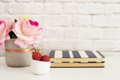 Pink Roses Mock Up. Styled Photography. Brick Wall Product Display. Strawberries On Striped Design Notebooks. Vase With Pink Roses stock image Pink Roses Mock Up. Styled Photography. Brick Wall Product Display. Strawberries On Striped Design Notebooks. Vase With Pink Roses stock image