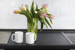 Pink tulips bouquet in glass vase on the kitchen royalty free stock photos Pink tulips bouquet in glass vase on the kitchen royalty free stock photos