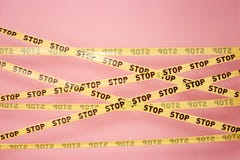 Pink wall with the yellow scotch tapes with inscriptions of word `stop` on it vector illustration Pink wall with the yellow scotch tapes with inscriptions of word `stop` on it vector illustration