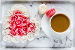 Pink and white roses in heart shaped box and coffee cup on marble table background. Delicious sweets and coffee break. Gift stock image Pink and white roses in heart shaped box and coffee cup on marble table background. Delicious sweets and coffee break. Gift stock image