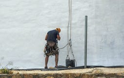Pintor que pinta uma parede branca em Múrcia foto de stock Pintor que pinta uma parede branca em Múrcia foto de stock