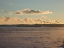 The pipes of the refinery in the port emit smoke into the atmosphere of the city and pollute the air royalty free stock photography The pipes of the refinery in the port emit smoke into the atmosphere of the city and pollute the air royalty free stock photography