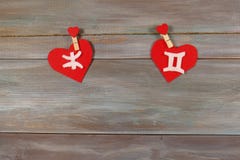 Pisces and twins. signs of the zodiac and heart. wooden backgrou stock image Pisces and twins. signs of the zodiac and heart. wooden backgrou stock image