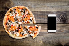 Pizza, Italian food delivery, call or order online on mobile, cellular, smart phone. royalty free stock photography Pizza, Italian food delivery, call or order online on mobile, cellular, smart phone. royalty free stock photography