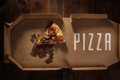 Pizza slice in the in delivery box on the wood royalty free stock images Pizza slice in the in delivery box on the wood royalty free stock images